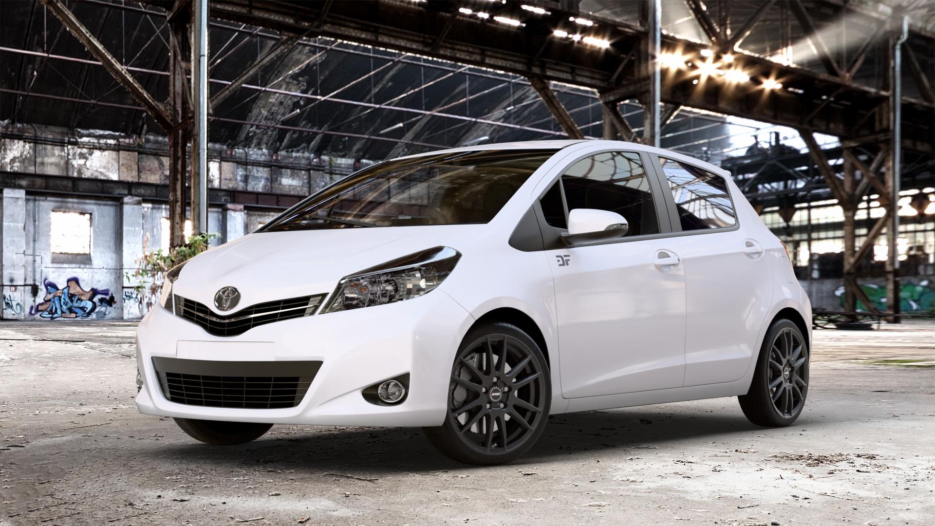 ALUTEC Monstr racing-schwarz Felge mit Reifen in 17Zoll Winterfelge Alufelge auf weissem Toyota Yaris III Typ XP13 Facelift 17-> ⬇️ mit 15mm Tieferlegung ⬇️ Old Industrial Hall_max_4400mm_2024 Frontansicht_1