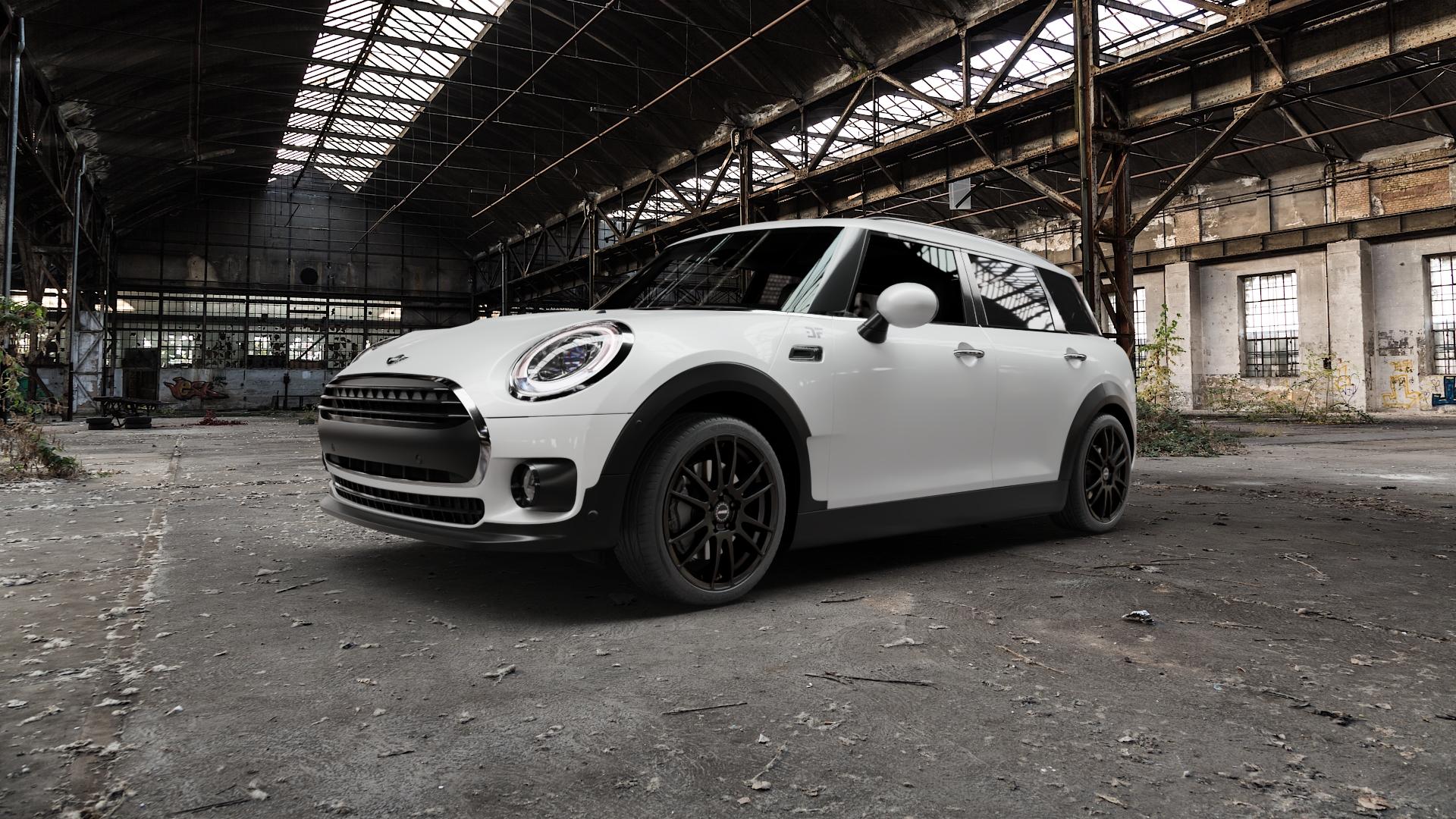 ALUTEC Monstr racing-schwarz Felge mit Reifen in 18Zoll Winterfelge Alufelge auf weissem Mini F54 Typ UKL-L (Clubman) FMK ⬇️ mit 15mm Tieferlegung ⬇️ Old Industrial Hall_max5000mm_2022 Frontansicht_1