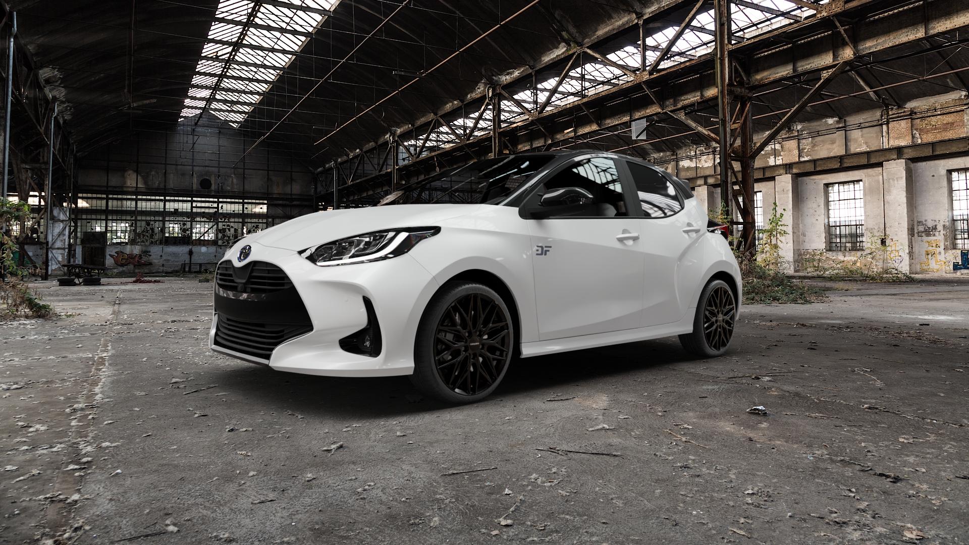 CARMANI 26 Max black Felge mit Reifen schwarz in 18Zoll Winterfelge Alufelge auf weissem Toyota Yaris IV Typ XPA1F(EU,M) XPA1F(EUM)-TGRE ⬇️ mit 15mm Tieferlegung ⬇️ Old Industrial Hall_max5000mm_2022 Frontansicht_1