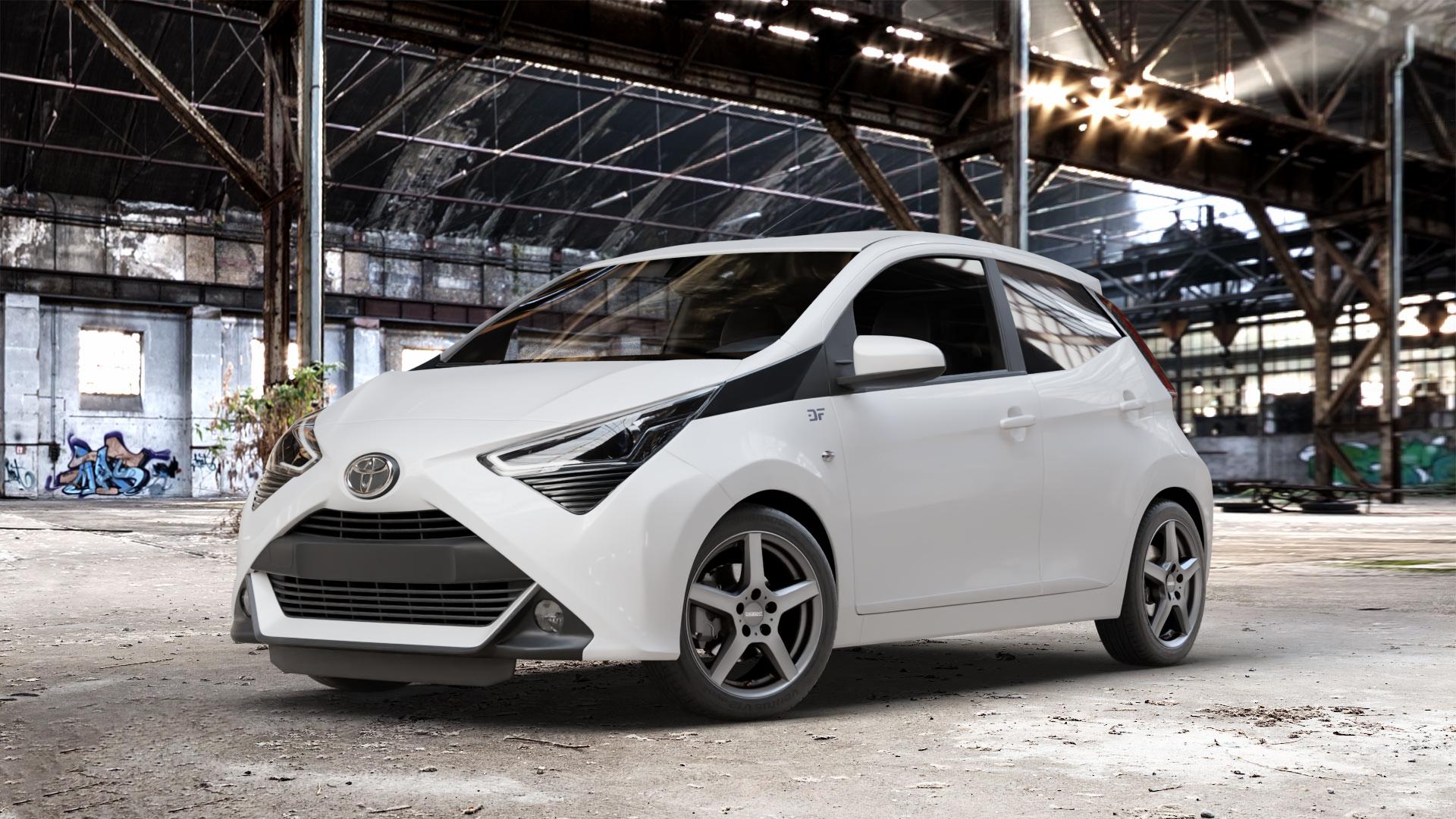 DEZENT TY GRAPHITE MATT Felge mit Reifen grau anthrazit in 15Zoll Winterfelge Alufelge auf weissem Toyota Aygo II Facelift ⬇️ mit 15mm Tieferlegung ⬇️ Old Industrial Hall_max_4400mm_2024 Frontansicht_1