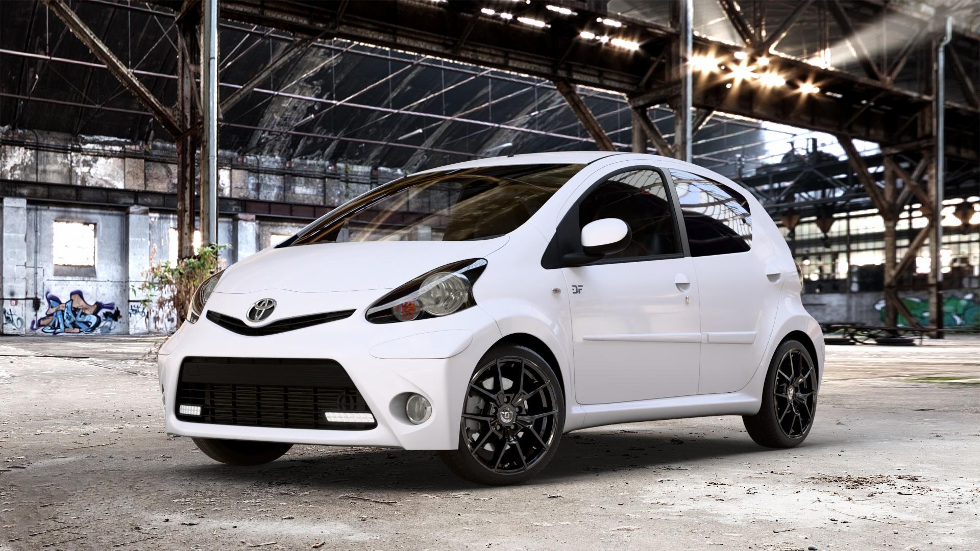 DIEWE WHEELS NEVE Black glossy Felge mit Reifen schwarz in 16Zoll Winterfelge Alufelge auf weissem Toyota Aygo I ⬇️ mit 15mm Tieferlegung ⬇️ Old Industrial Hall_max_4400mm_2024 Frontansicht_1