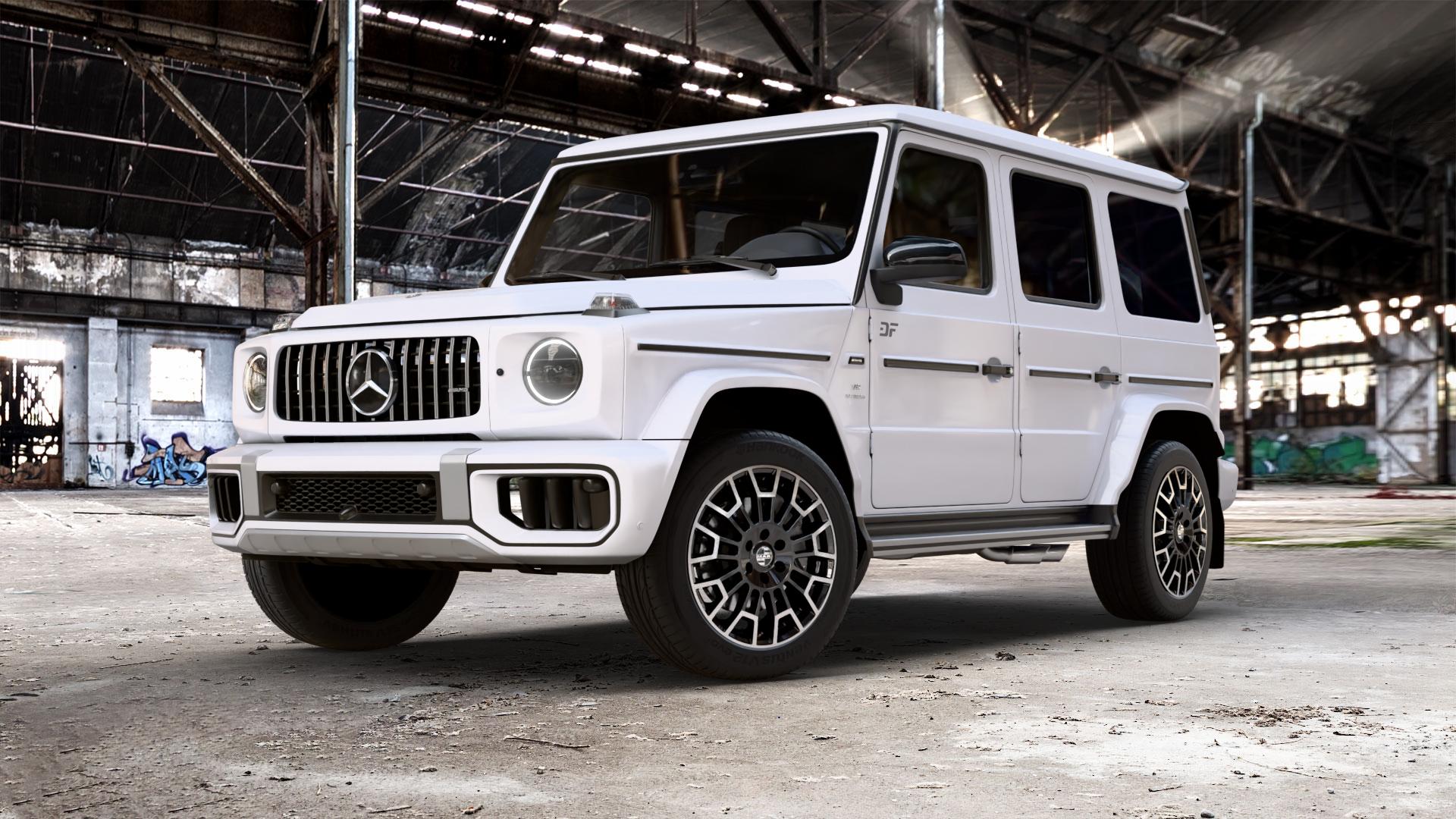 MAK Nomad Black Mirror Felge mit Reifen schwarz in 20Zoll Alufelge auf weissem Mercedes G-Klasse Typ W465 3,0l G 450d 270kW Mild-Hybrid (367 PS) 500 330kW (449 0,0l 580 EQ 223kW (303 4,0l 63 AMG 430kW (585 ⬇️ mit 15mm Tieferlegung ⬇️ Old Industrial Hall_max_5300mm_2024 Frontansicht_1