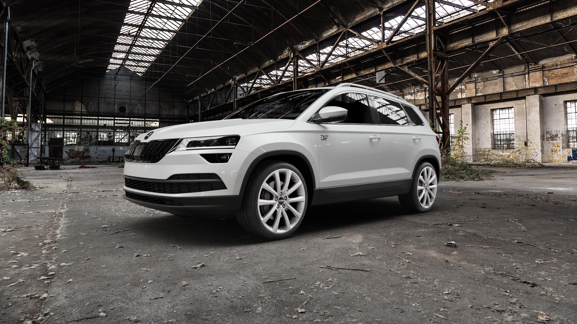 OXXO Liberty silver Felge mit Reifen silber in 19Zoll Winterfelge Alufelge auf weissem Skoda Karoq Typ NU Scout ⬇️ mit 15mm Tieferlegung ⬇️ Old Industrial Hall_max5000mm_2022 Frontansicht_1