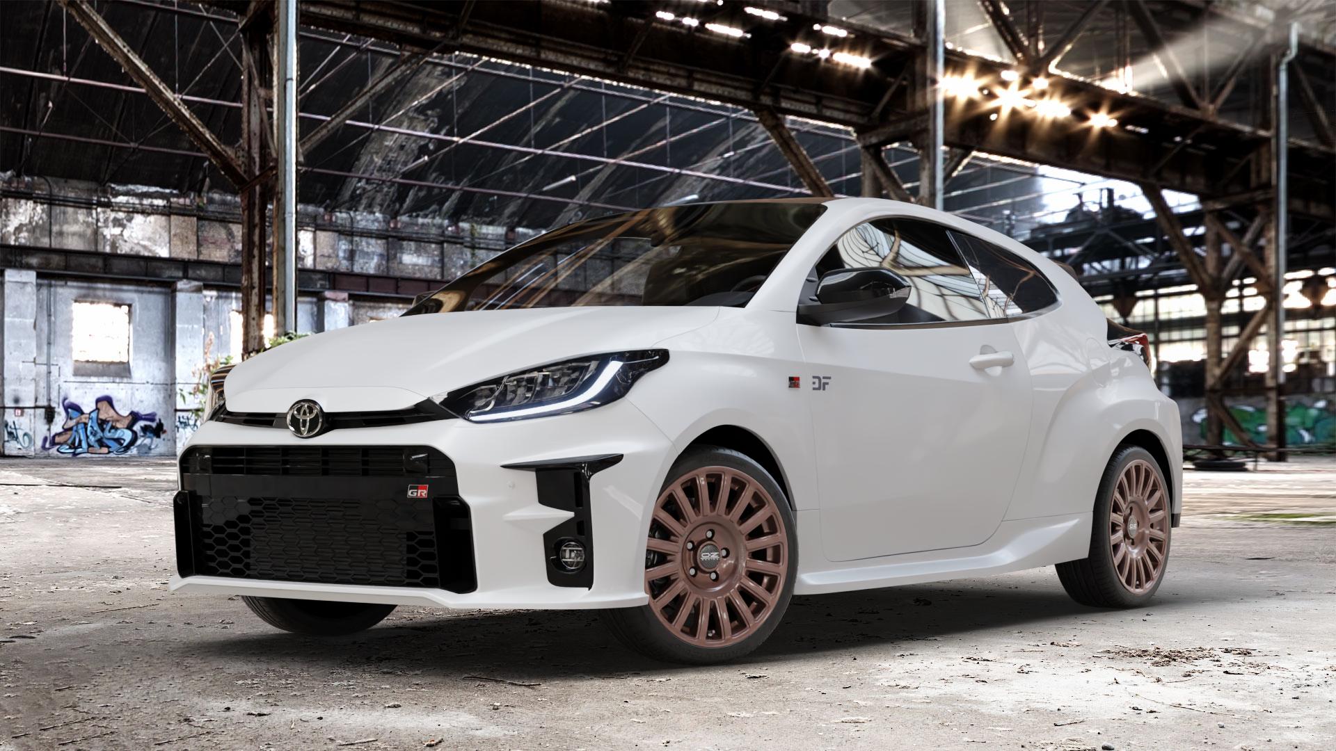 OZ RACING RALLY RAID GLOSS BRONZE + BLACK LETTERING Felge mit Reifen schwarz in 18Zoll Winterfelge Alufelge auf weissem Toyota Yaris IV Typ XPA1F(EU,M) l kW (0 PS) GR XPA1G(EU,M) ⬇️ mit 15mm Tieferlegung ⬇️ Old Industrial Hall_max_4400mm_2024 Frontansicht_1