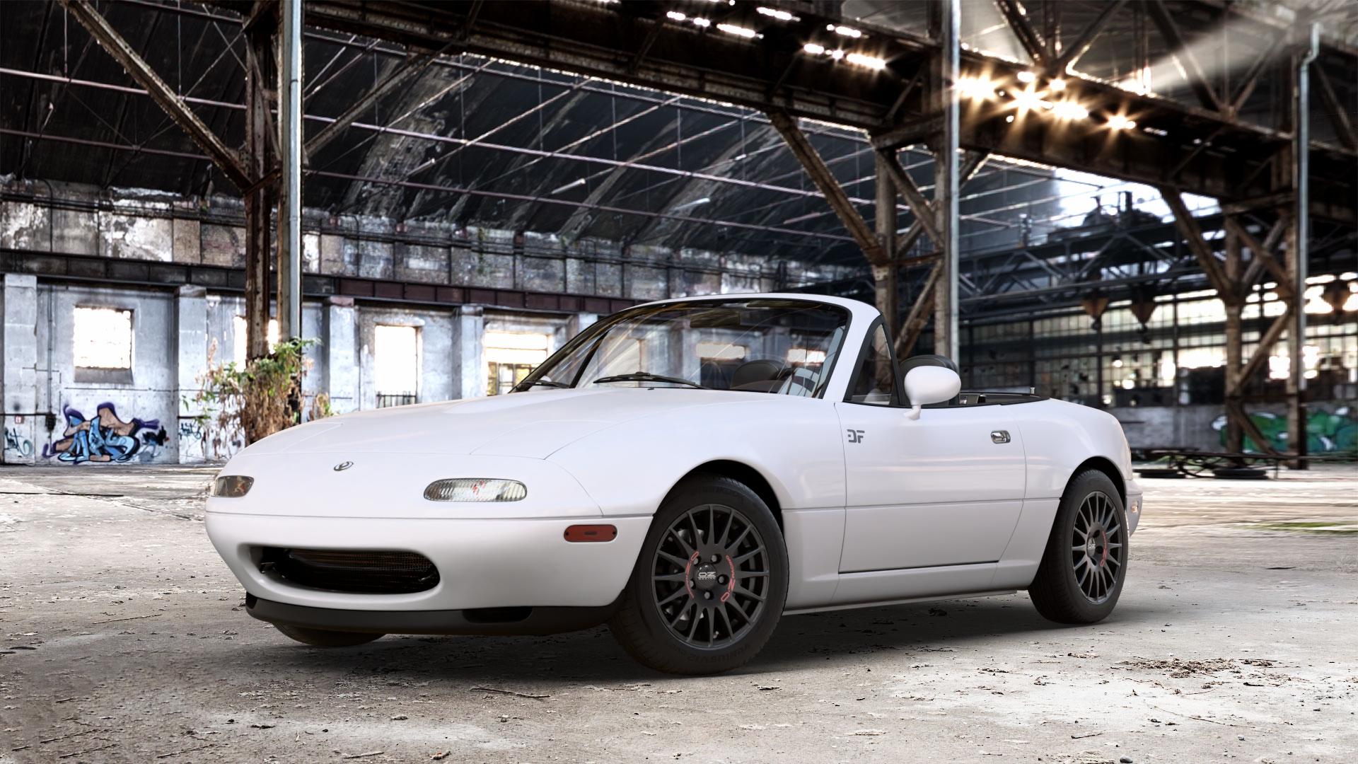 OZ RACING SUPERTURISMO GT MATT BLACK Felge mit Reifen schwarz schwarz matt in 14Zoll Winterfelge Alufelge auf weissem Mazda MX-5 I (NA) ⬇️ mit 15mm Tieferlegung ⬇️ Old Industrial Hall_max_4400mm_2024 Frontansicht_1