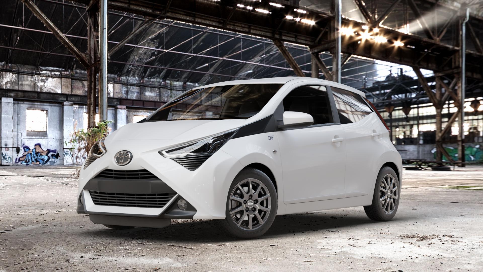 RIAL Milano titanium Felge mit Reifen grau in 14Zoll Winterfelge Alufelge auf weissem Toyota Aygo II Facelift ⬇️ mit 15mm Tieferlegung ⬇️ Old Industrial Hall_max_4400mm_2024 Frontansicht_1