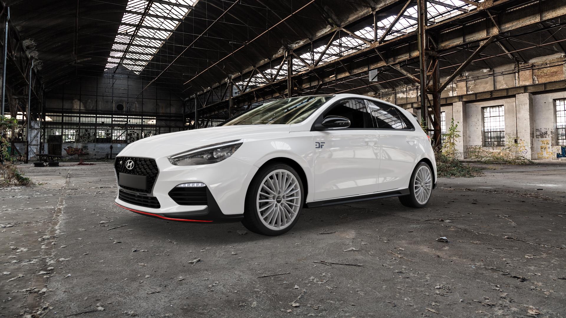 RONAL R68 HYPER GREY Felge mit Reifen grau silber in 18Zoll Winterfelge Alufelge auf weissem Hyundai i30 Typ PDE 2,0l T-GDI 184kW N (250 PS) 202kW Performance (275 ⬇️ mit 15mm Tieferlegung ⬇️ Old Industrial Hall_max5000mm_2022 Frontansicht_1