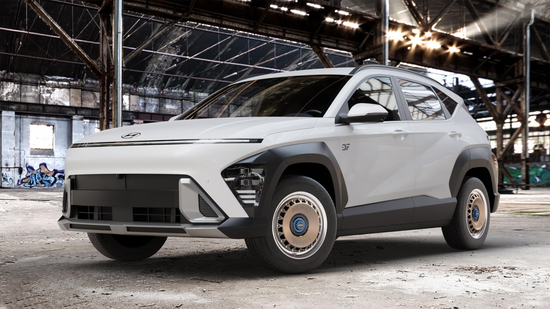 RONAL RR10 REV M BRONZE MATT Felge mit Reifen in 16Zoll Alufelge auf weissem Hyundai Kona Typ SX2 ⬇️ mit 15mm Tieferlegung ⬇️ Old Industrial Hall_max_4400mm_2024 Frontansicht_1