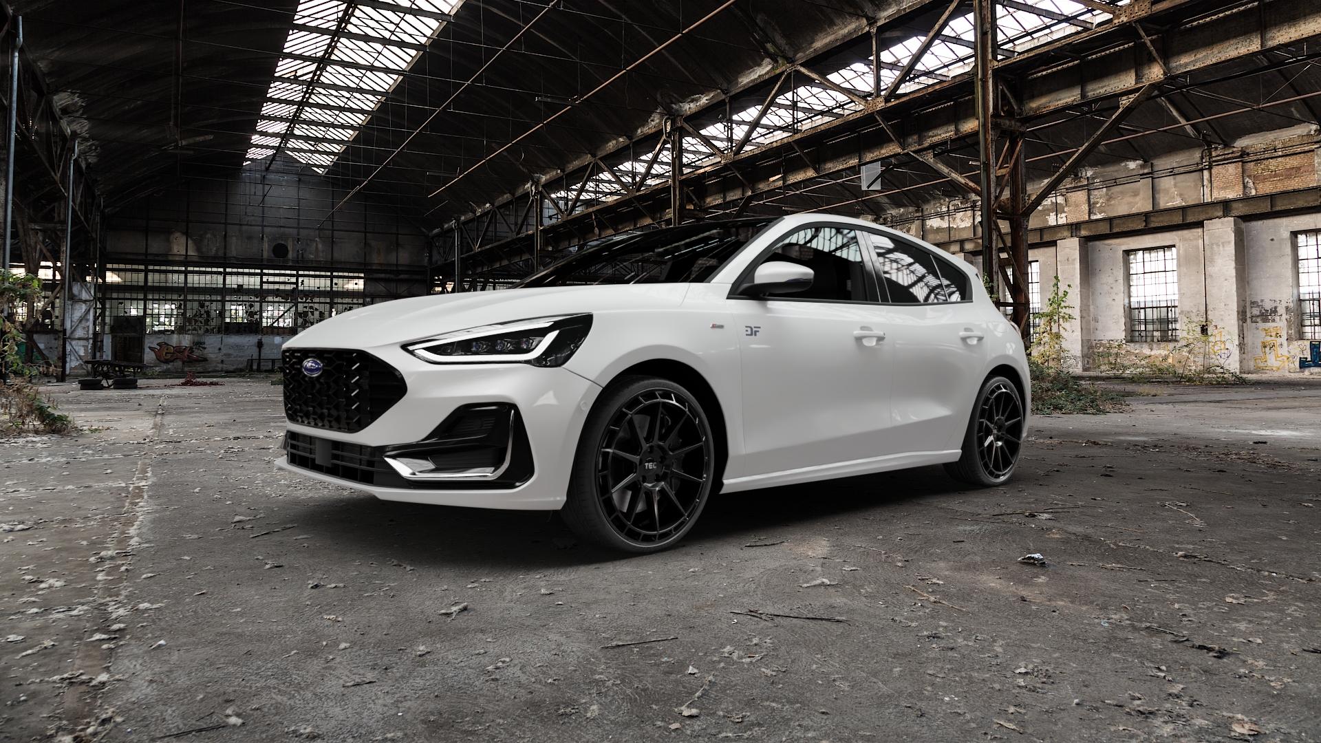 Tec Speedwheels GT8 Schwarz Glanz Felge mit Reifen in 20Zoll Winterfelge Alufelge auf weissem Ford Focus IV Typ DEH Facelift (Schrägheck) 1,0l EcoBoost 74kW (101 PS) 92kW (125 Mild-Hybrid 114kW (155 1,5l EcoBlue 88kW (120 91kW (124 Flexfuel ⬇️ mit 15mm Tieferlegung ⬇️ Old Industrial Hall_max5000mm_2022 Frontansicht_1